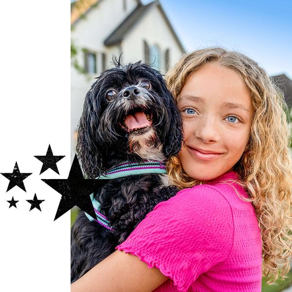 Girl With Small Dog on sidewalk