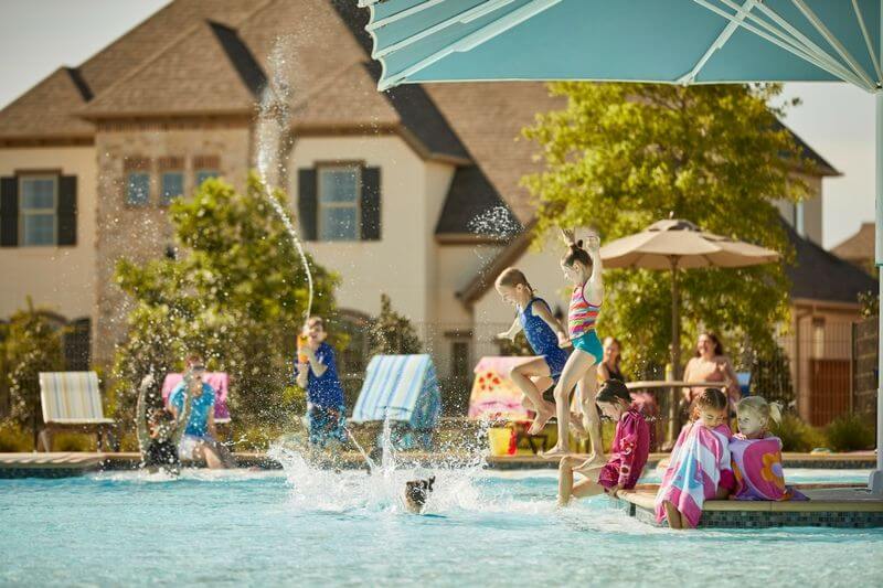 Kids playing at Elyson House Pool in Katy community.