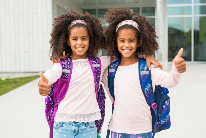 Twin girls enjoy school in Elyson.