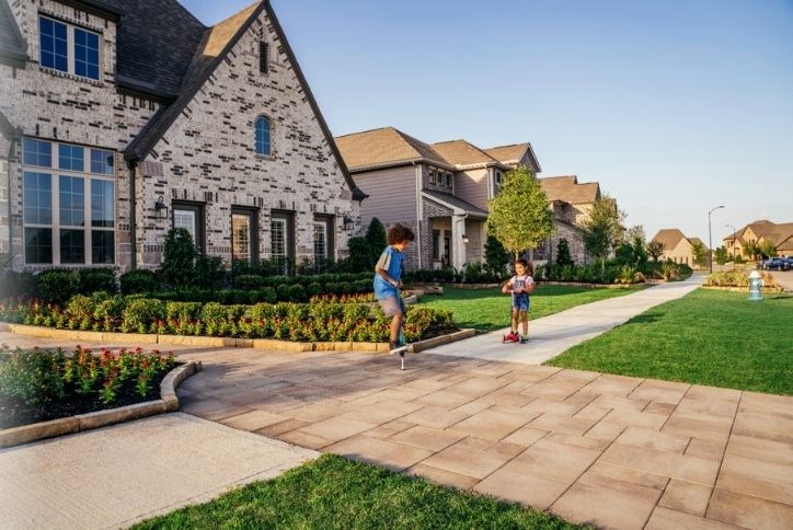 Kids playing in front of a home on a street in Elyson in Katy, Texas