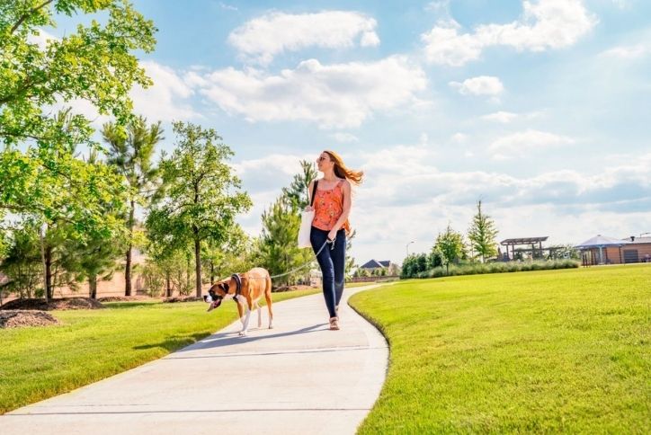 Woman Walking Dog in Elyson Community