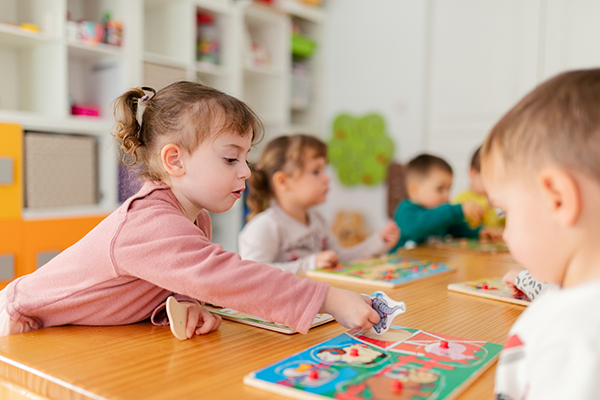Toddlers playing puzzles in pre-school, Katy, Texas