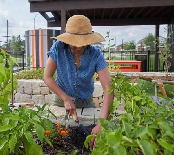 Lady gardening at Elyson Commons