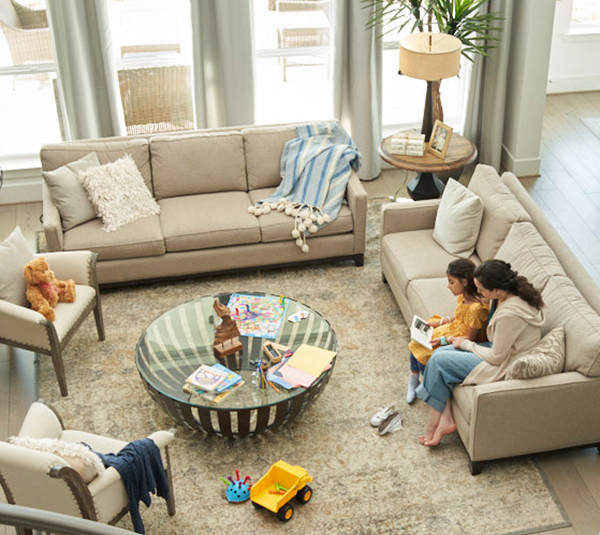 Mom and daughter reading in the living room of their home in Elyson