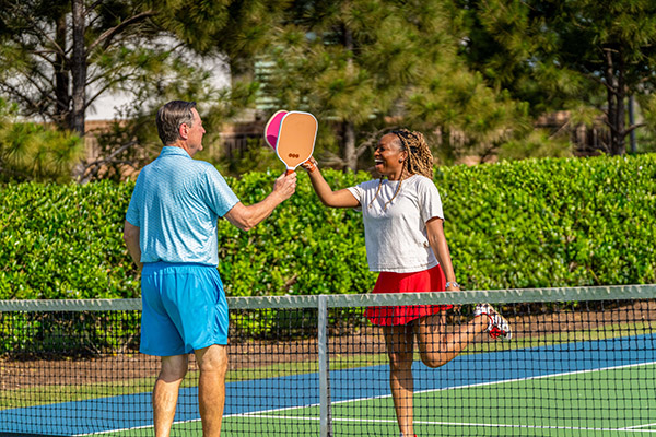 Two Adults Playing Pickleball