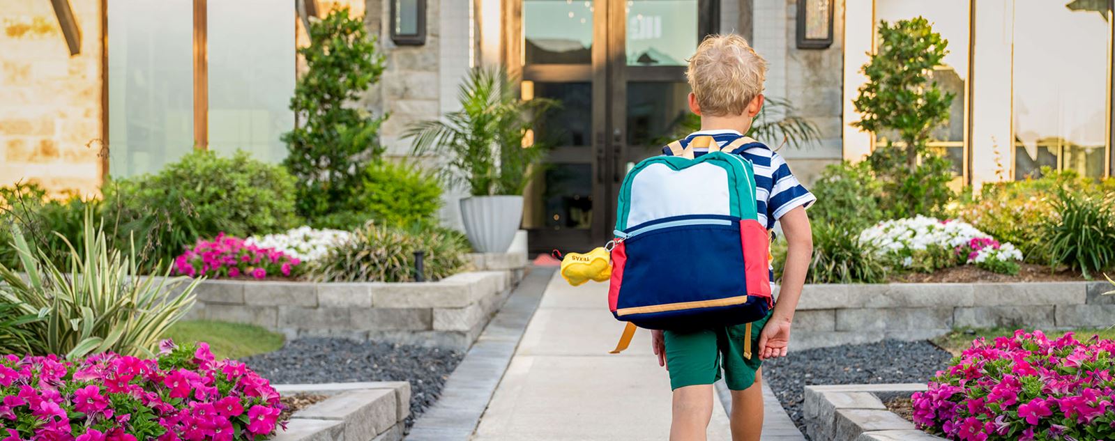 Boy In Backpack Walking Up To House