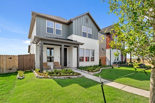 New construction home exterior by Brookfield Residential at Elyson in Katy, TX with white brick, board-and-batten siding, and covered front porch